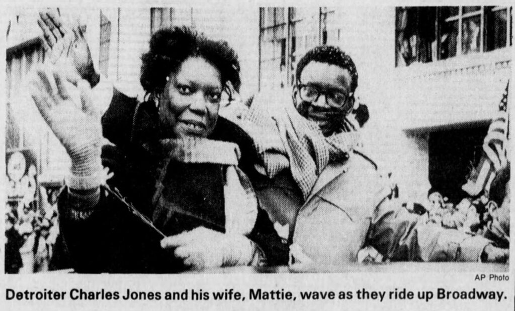 detroiter charles jones and his wife mattie wave as they ride up broadway
