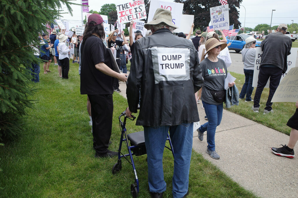 old man with walker and dump trump sign