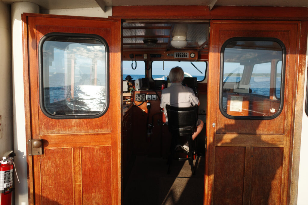 boating towards high island with ruins