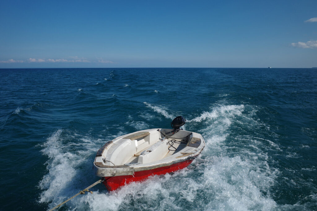 boating towards high island with ruins