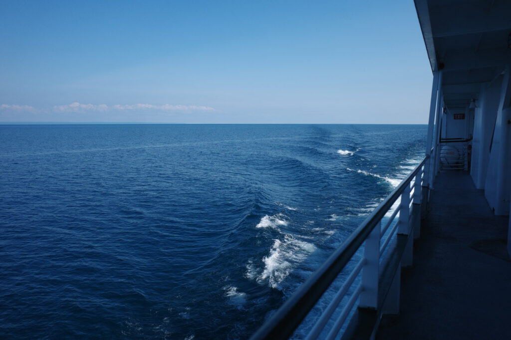 boating towards high island with ruins