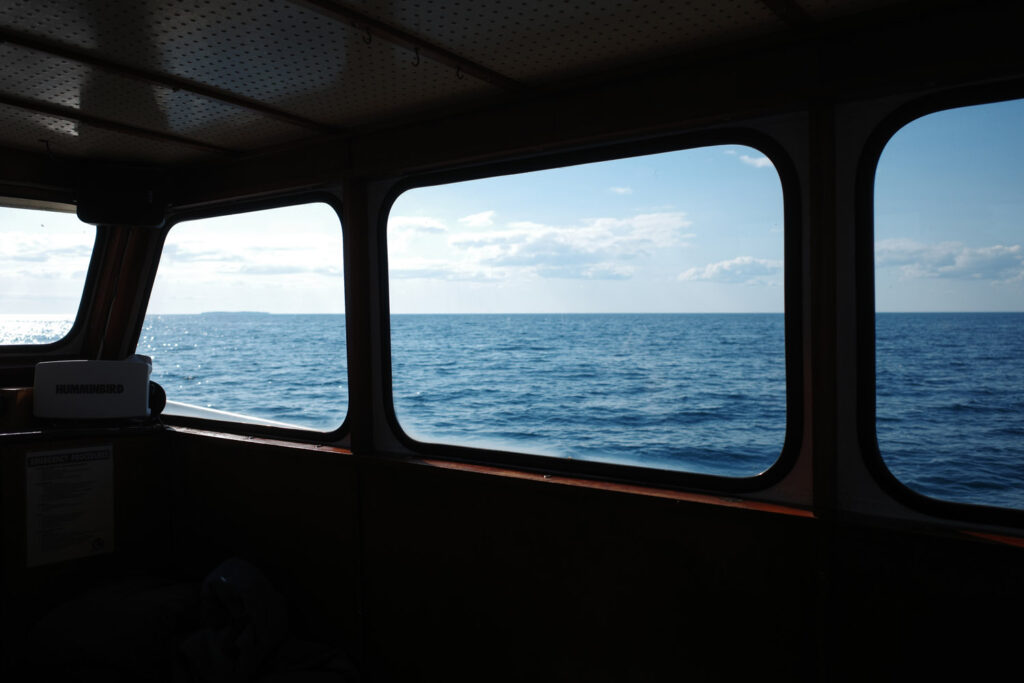 boating towards high island with ruins