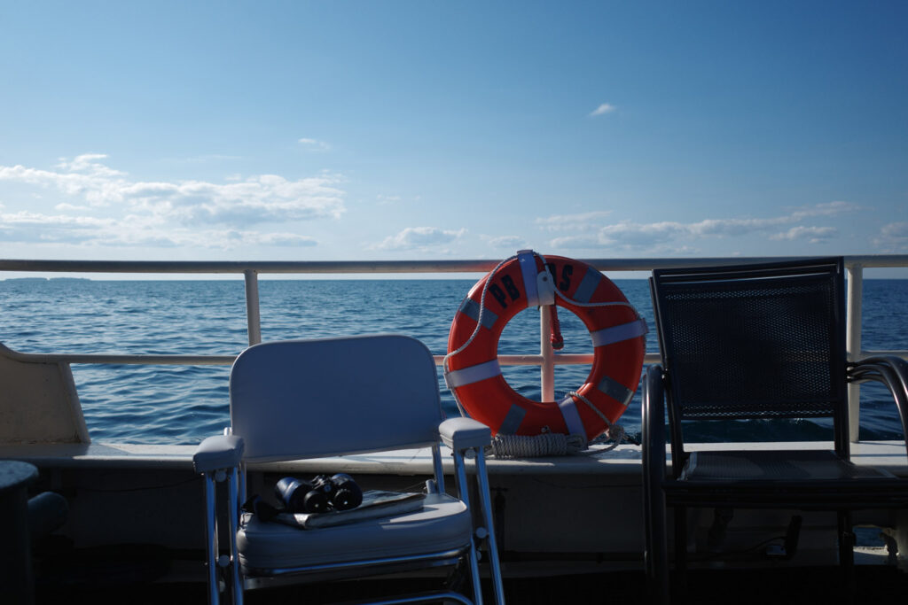 boating towards high island with ruins