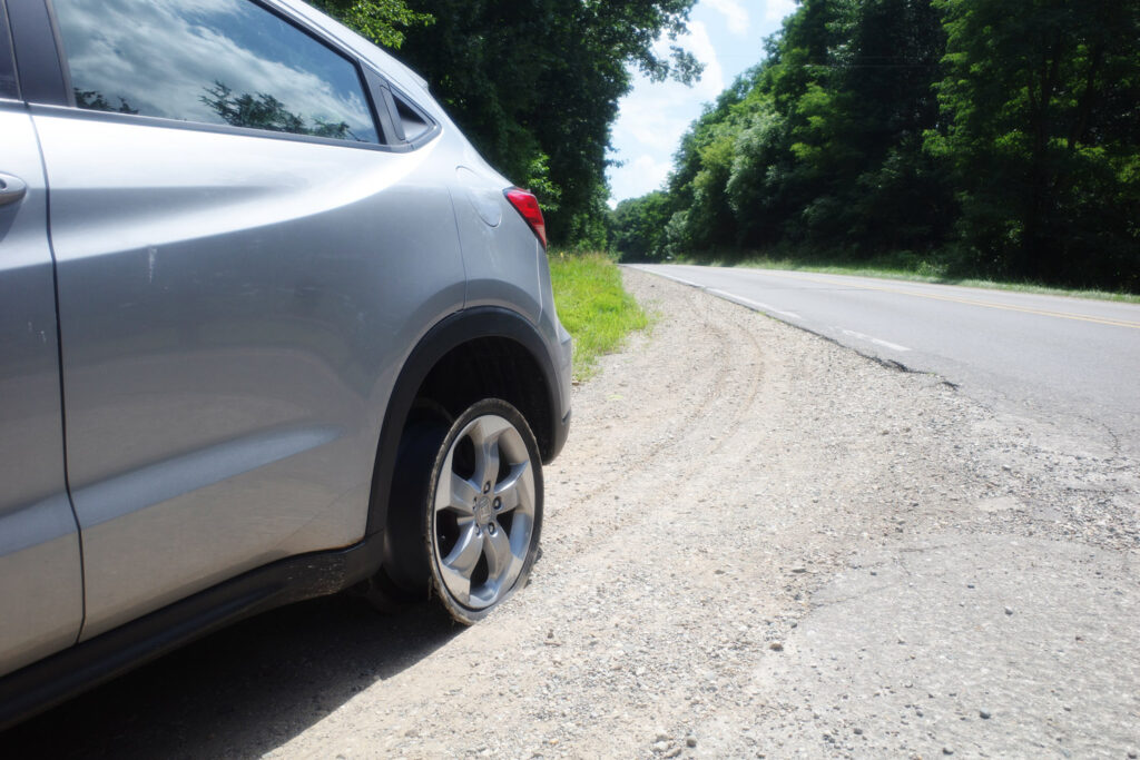 car with tire blown off