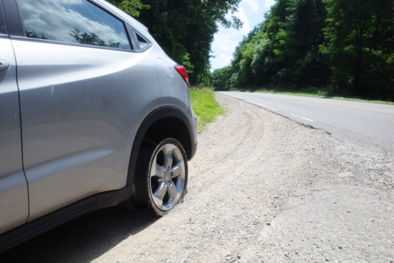 car with tire blown off
