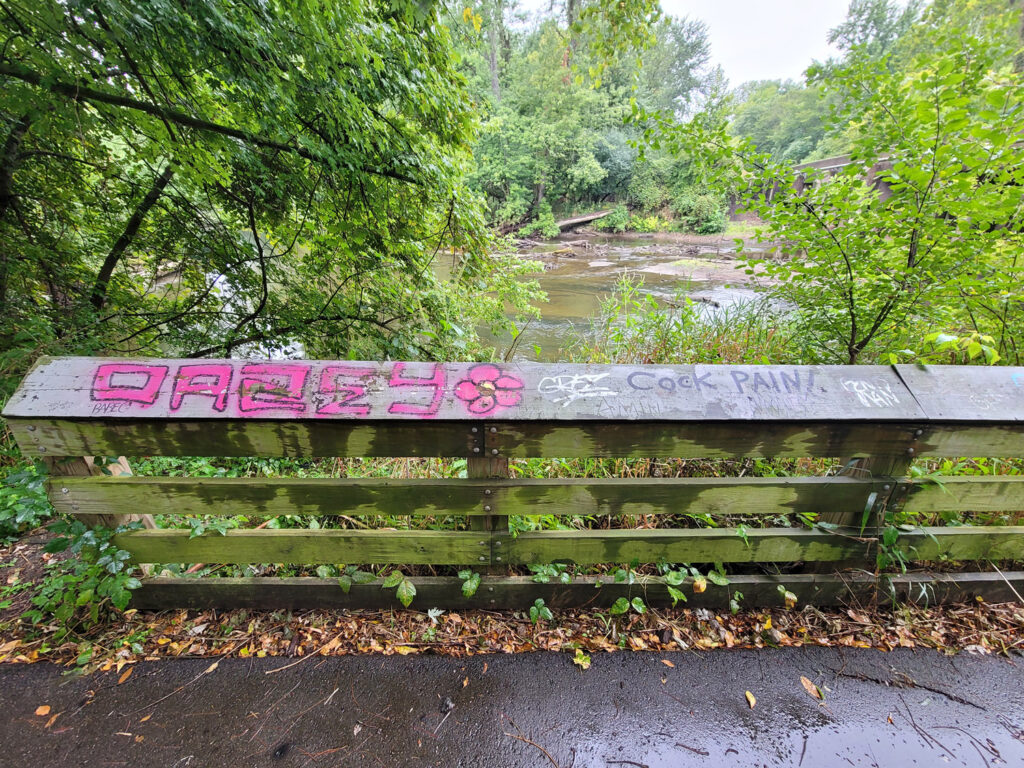 Lansing trail system with homeless encampments and graffiti