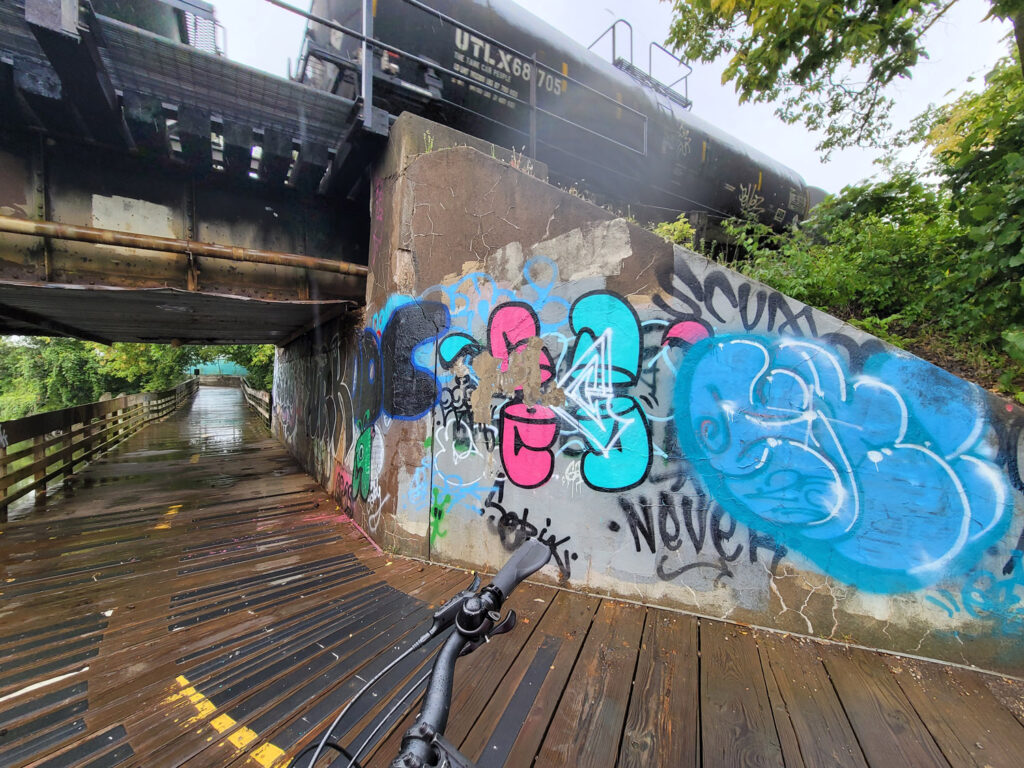 Lansing trail system with homeless encampments and graffiti
