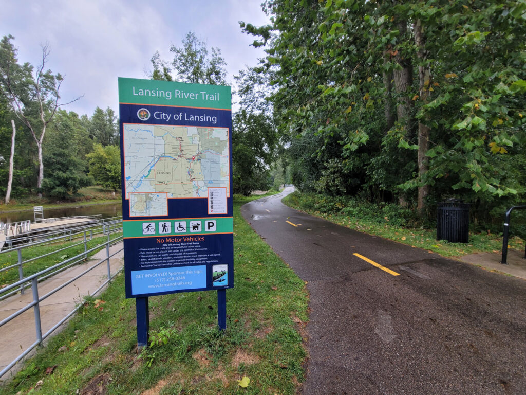 Lansing trail system with homeless encampments and graffiti