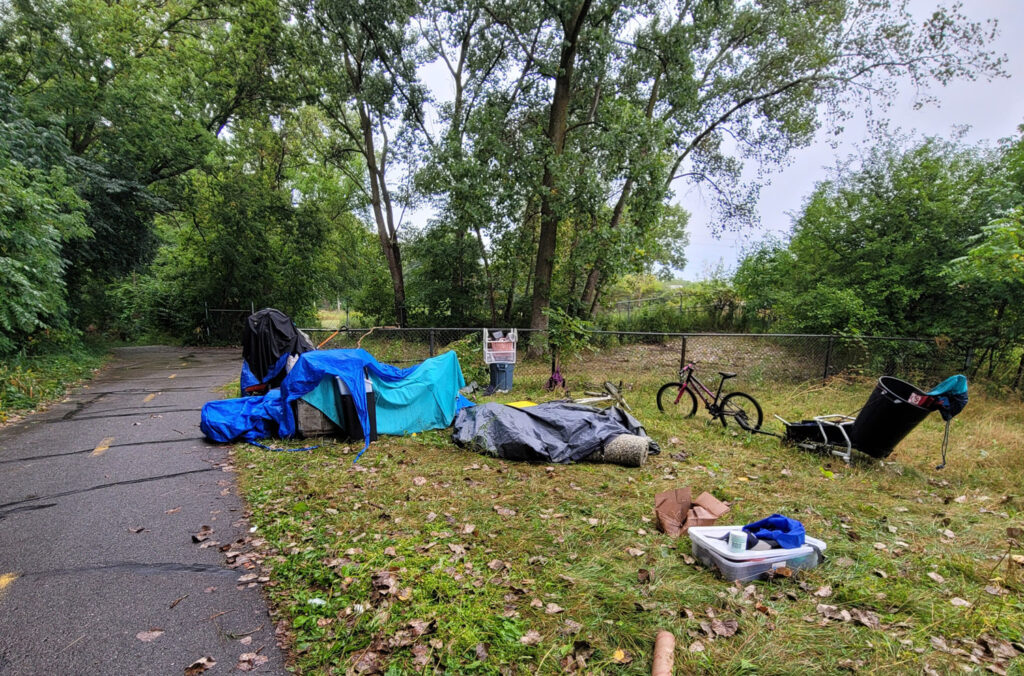 Lansing trail system with homeless encampments and graffiti