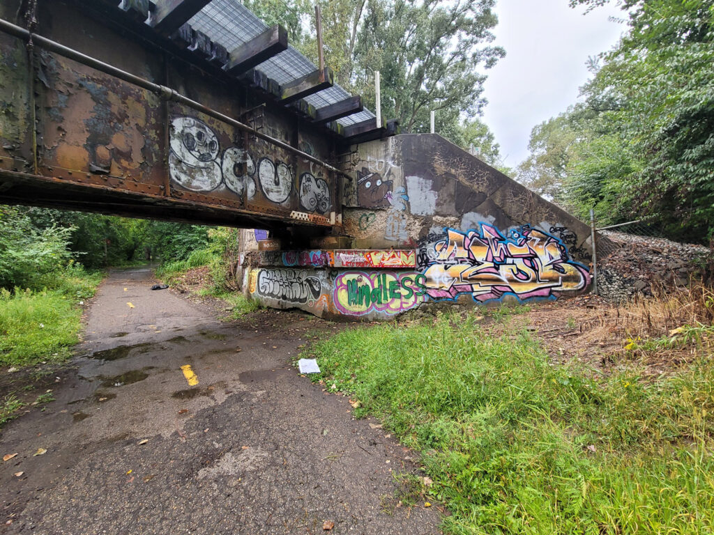 Lansing trail system with homeless encampments and graffiti