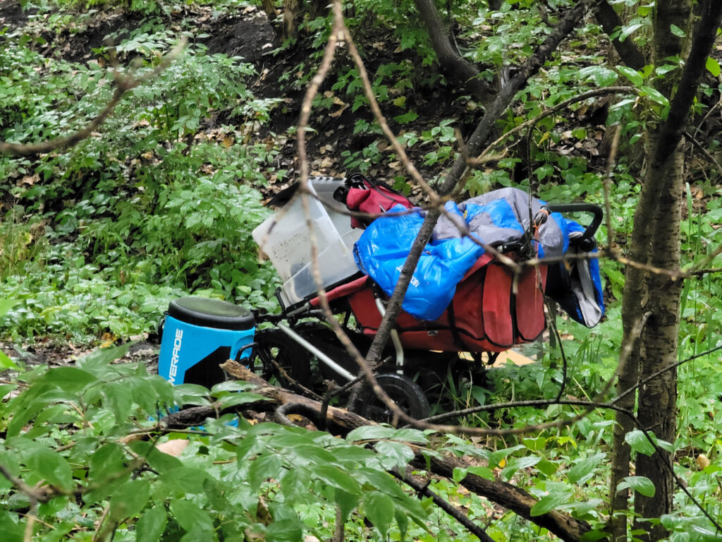 Lansing trail system with homeless encampments and graffiti