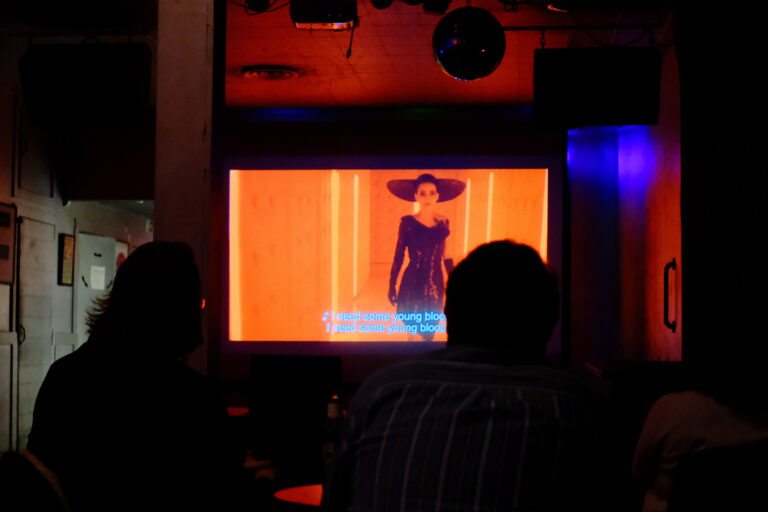 movie screening in bar with people and drinks