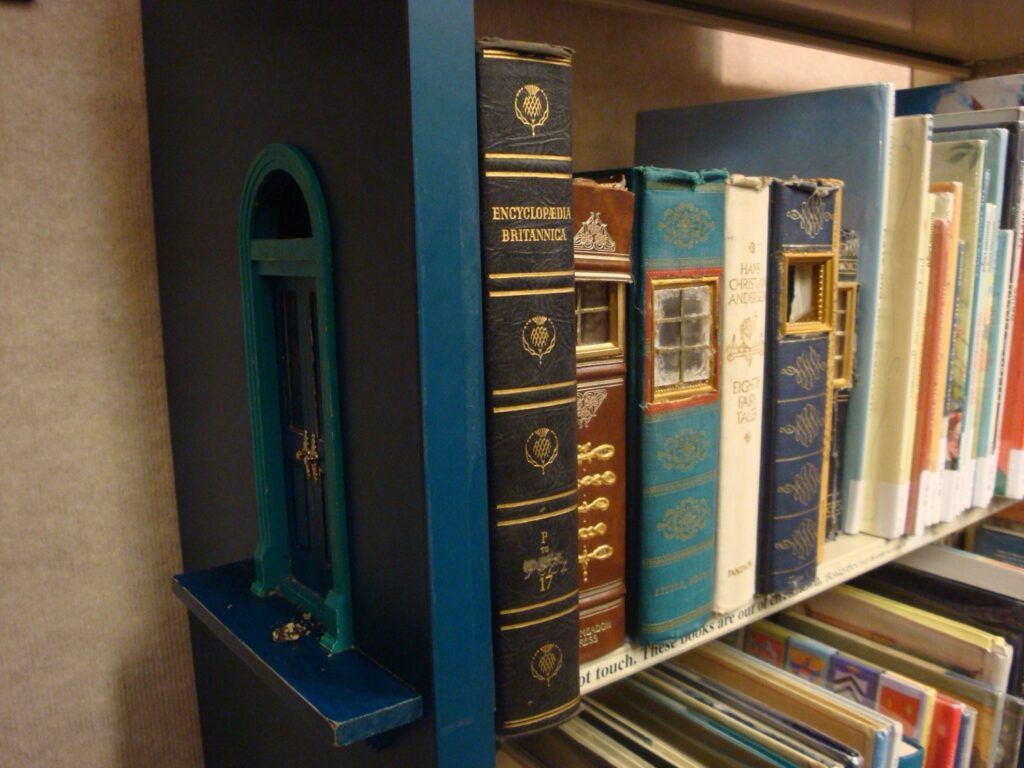 Shelves filled with books, including an Encyclopedia Britannica volume, in what appears to be a library or bookshop.