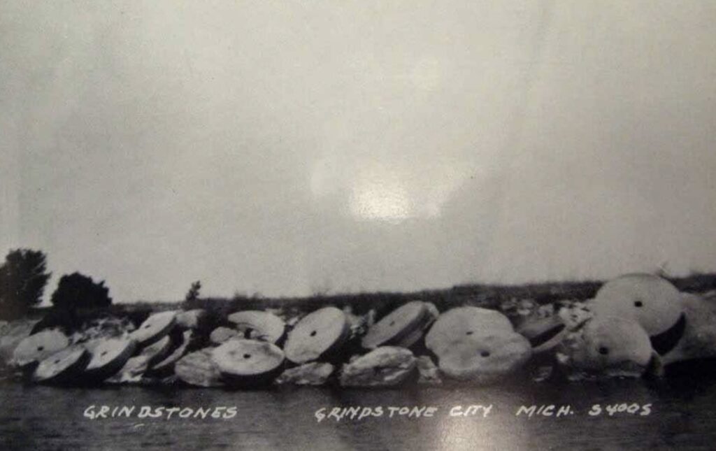 A snowy landscape showing large grindstones, likely the Grindstone City marker referenced in the article.